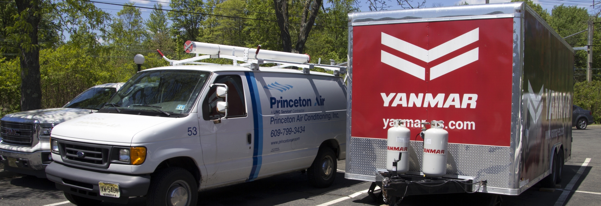 Princeton Work Vehicle Next To Yanmar Trailer