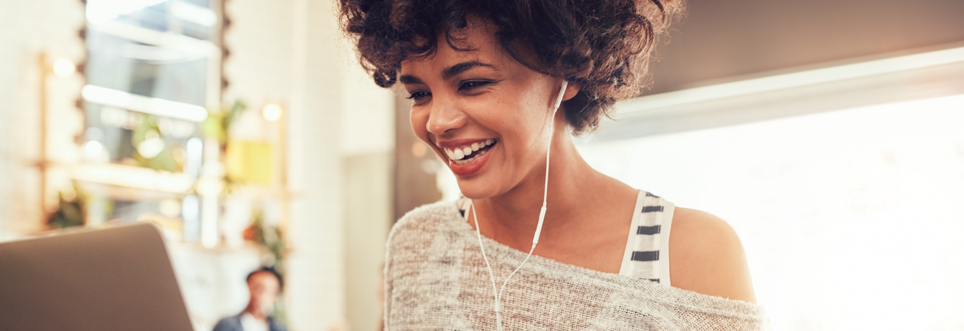 Woman Smiling As She Uses Her Computer