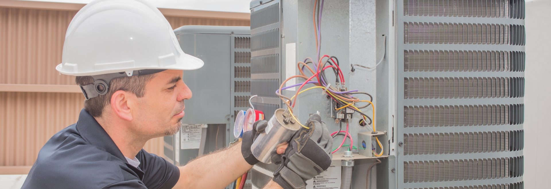 Technician Working On Commercial HVAC Unit