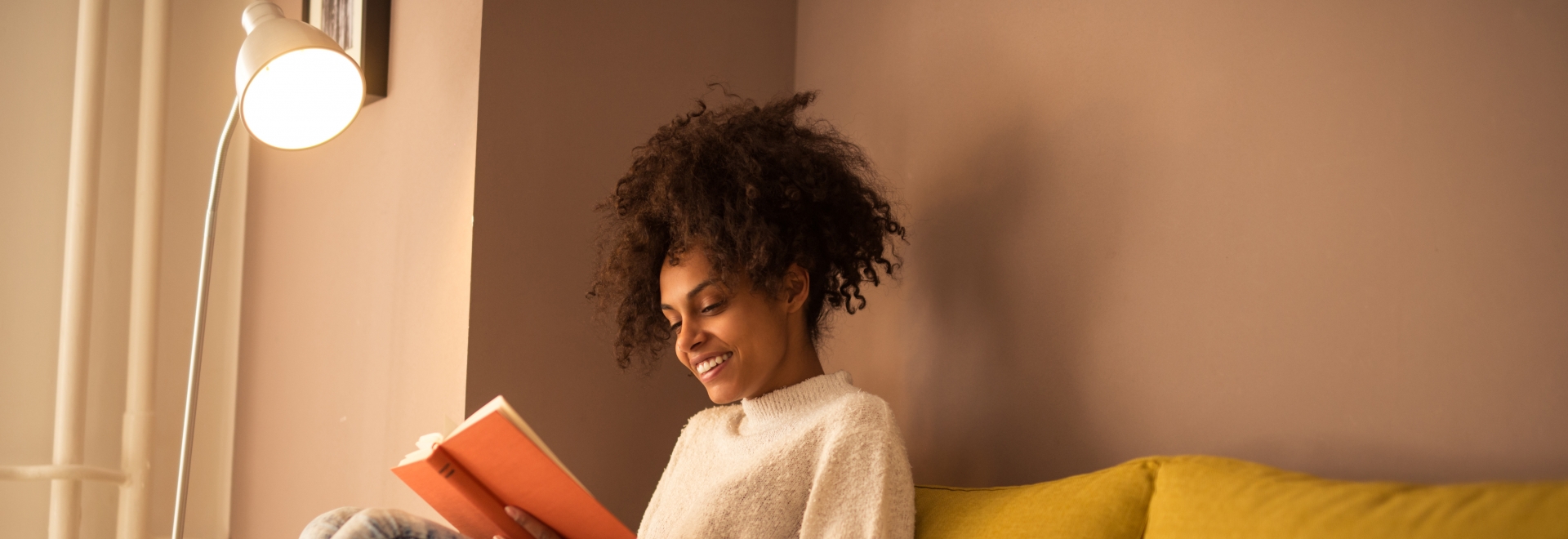 Woman Reading Book Under A Lamp