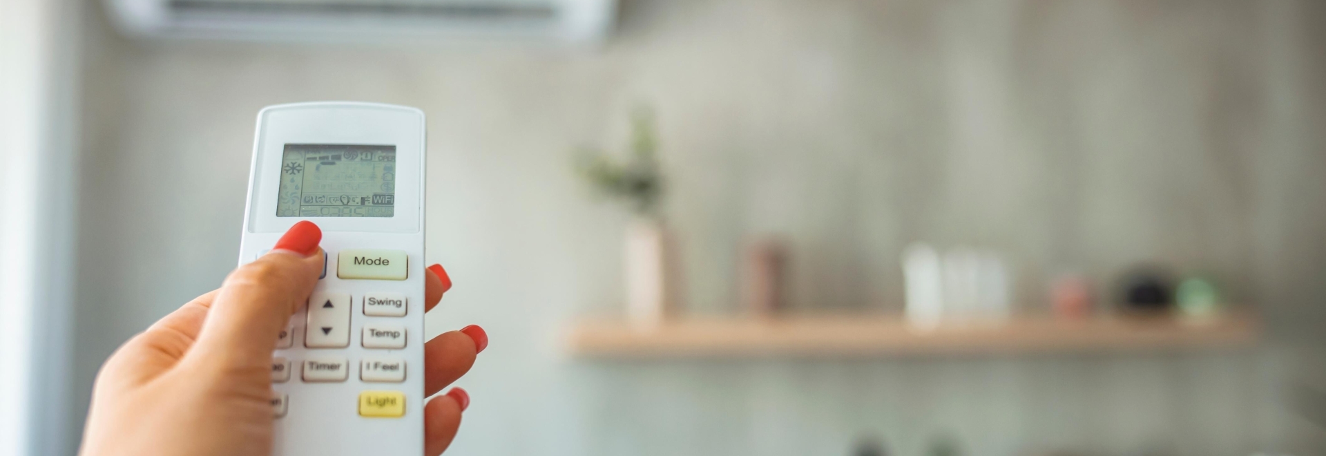 person pointing a remote at their heat pump