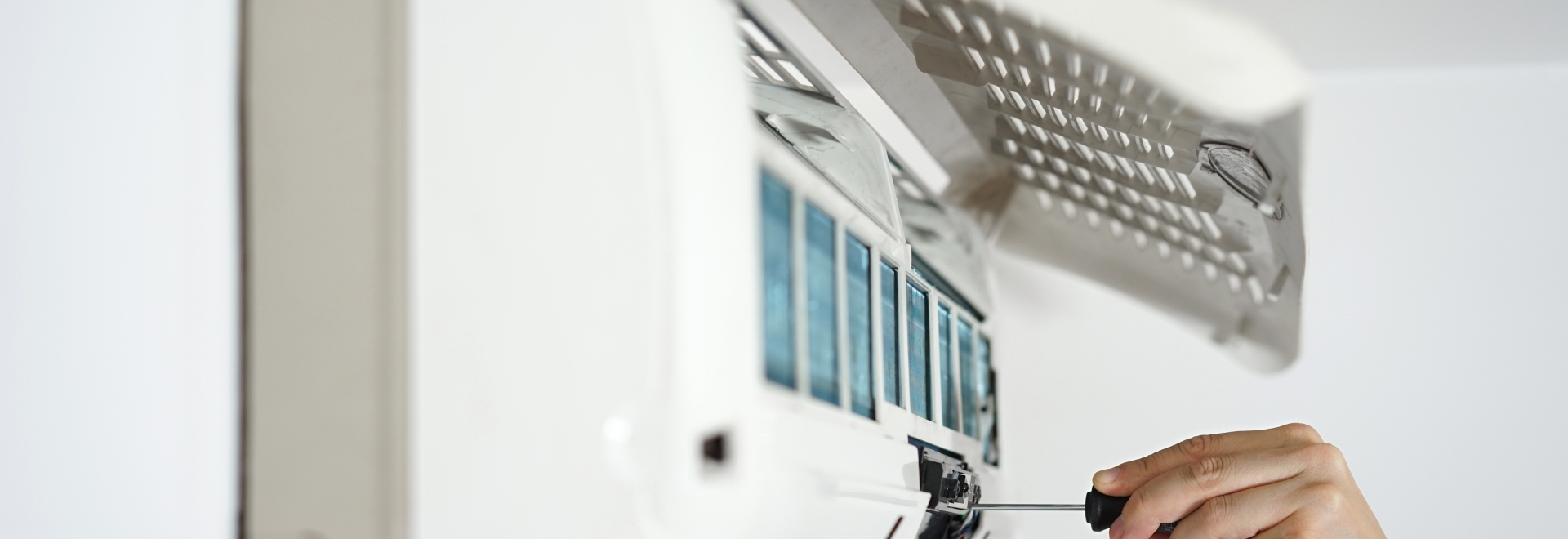 person working on a heat pump