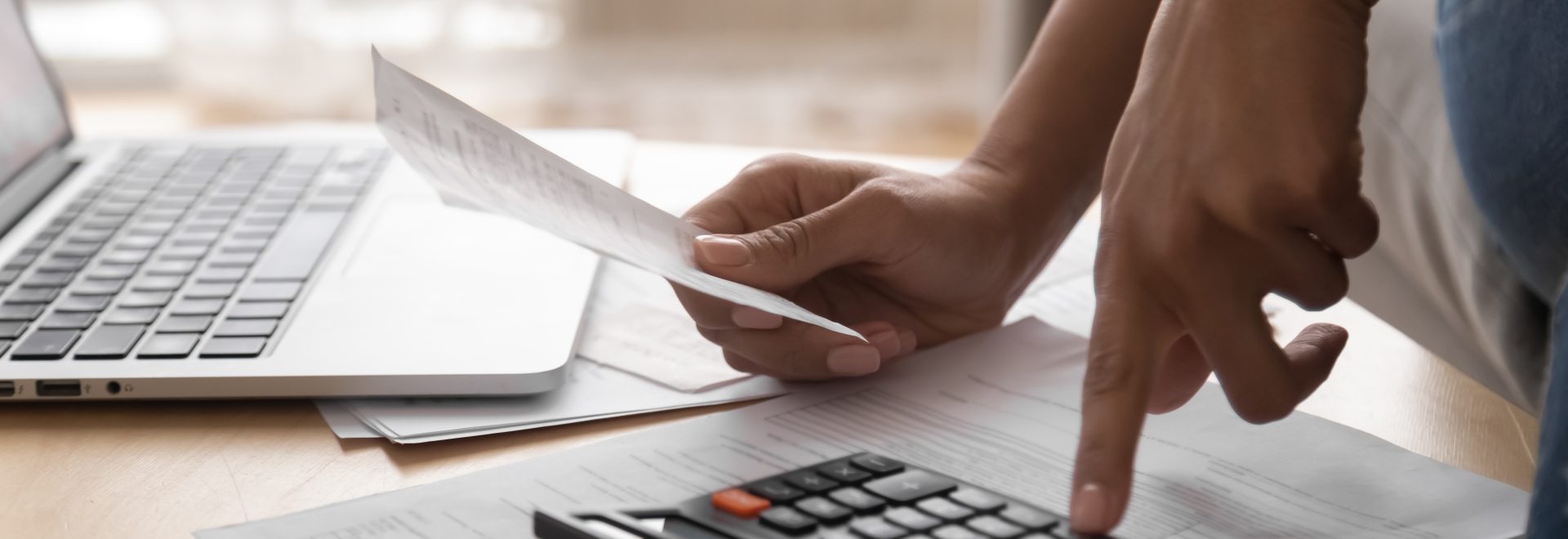 person using a calculator for tax return