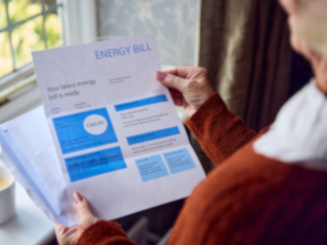 woman looking at her energy bill