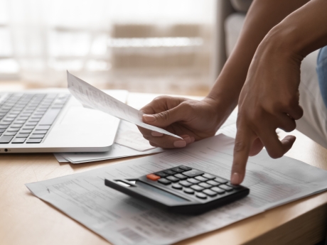 person using a calculator for tax return